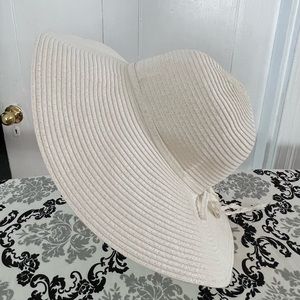 White floppy sun hat. One size fits all. Minimal wear.